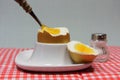 Golden egg in an egg cup on a red patterned napkin Royalty Free Stock Photo