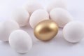 Golden egg and jast eggs on a white Royalty Free Stock Photo