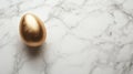golden egg on marble surface, symbolizing luxury and elegance Royalty Free Stock Photo