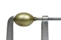 Golden Egg in Metal Clamp Royalty Free Stock Photo