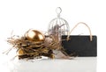 Golden egg in nest with blackboard with space for text Royalty Free Stock Photo