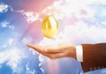 Golden Egg Over Male Hand Royalty Free Stock Photo