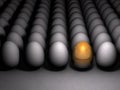 A golden egg that stands out. Future possibilities and promising options. Many eggs are lined up side by side. Royalty Free Stock Photo