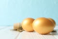 Golden eggs and money on against blue background Royalty Free Stock Photo