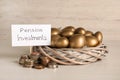 Golden eggs in nest, coins and card with phrase Pension Investments on white wooden table Royalty Free Stock Photo