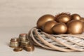 Golden eggs in nest and coins on white wooden table. Pension concept Royalty Free Stock Photo