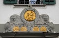 Golden emblems on the exterior wall of a building at Muehlenplatz in Lucerne