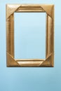 Golden empty frame levitating on light blue Royalty Free Stock Photo