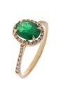 Golden engagement ring with diamonds and emerald, isolated on white