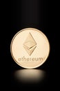 Golden Ethereum coin, cryptocurrency on black, clipping path