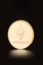 Golden Ethereum coin, cryptocurrency on black