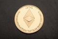 Golden ethereum, cryptocurrency on black wooden table