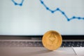 Golden ethereum on notebook keyboard with increasing chart