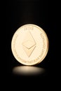 Golden Ethereum, physical cryptocurrency on black, clipping path