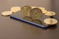 Golden Etherium coin close up on smartphone - business concept of crypto currency.