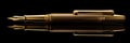 Golden exquisite gold fountain pen on black background, expensive fountain ink pen, banner Royalty Free Stock Photo