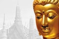 The golden face of the old Buddha statue with temple backdrop in Royalty Free Stock Photo