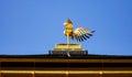 Golden fenix statue on the top of temple