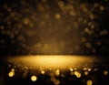 Golden festive abstract shiny glitter dark background with blurred bokeh stage light Royalty Free Stock Photo