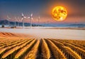 Wind turbines in wheat field and full moon at sunset, 3D rendering, generative ai Royalty Free Stock Photo