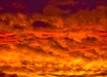 Golden Fiery Sunset with layered Clouds