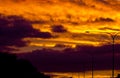 Golden Fiery Sunset with layered Clouds