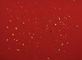 Golden flakes of potal on red textured paper