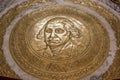 Golden floor seal with George Washington`s face