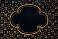 Golden floral frame painted on black wooden background