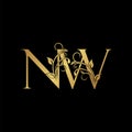 Golden floral letter N and W, NW logo Icon, Luxury alphabet font initial vector design isolated on black background Royalty Free Stock Photo