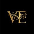 Golden floral letter V and E, VE logo Icon, Luxury alphabet font initial vector design isolated on black background Royalty Free Stock Photo