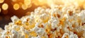 Golden fluffy popcorn close up freshly popped kernels revealing white interiors on dark background Royalty Free Stock Photo