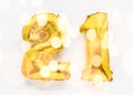 21 golden foil balloon numbers party decor on white background, birthday concept with festive lights