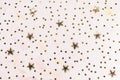 Golden foil confetti stars on pink background Royalty Free Stock Photo