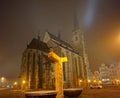 Golden fountain with a cathedral tower in the background in foggy early morning