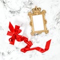 Golden frame gift box red ribbon bow Flat lay Royalty Free Stock Photo