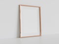 Golden frame leaning on white floor in interior mockup. Template of a picture framed on a wall 3D rendering Royalty Free Stock Photo