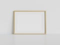 Golden frame leaning on white floor in interior mockup. Template of a picture framed on a wall 3D rendering Royalty Free Stock Photo