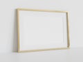 Golden frame leaning on white floor in interior mockup. Template of a picture framed on a wall 3D rendering Royalty Free Stock Photo