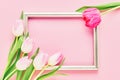 Golden frame with pink tulips on pink background. Mockup. Top view, copy space Royalty Free Stock Photo
