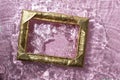 golden frame spashing on water surface with sandy pink glitter