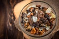 Golden fried forest mushrooms with onion in a bowl on wooden background