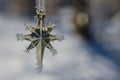 Golden Frost Covered Christmas Star Decorating an Outdoor Tree