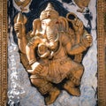 Golden Ganesha god of success with offers in the wall