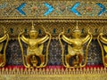 Golden garuda holding naga statue row with ornamental decoration Royalty Free Stock Photo