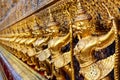 Golden garuda and naga statue, decoration on a wall of The Emerald Buddha temple, Wat Phra Kaew, Grand Palace, Bangkok, Thailand Royalty Free Stock Photo