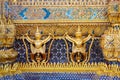 Golden garuda and naga statue, decoration on a wall of The Emerald Buddha temple, Wat Phra Kaew, Grand Palace, Bangkok, Thailand Royalty Free Stock Photo