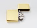 Golden gasoline lighter with a wick on a white background