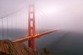 Golden gate bridge covered with fog at dusk Royalty Free Stock Photo