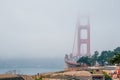 Golden Gate bridge covered in the fog under a cloudy sky in San Francisco, California Royalty Free Stock Photo